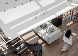A modern spa suite featuring minimalist design, wood furniture, fabric seating, and glass elements.