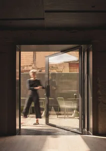 A minimalist open door with glass panels.