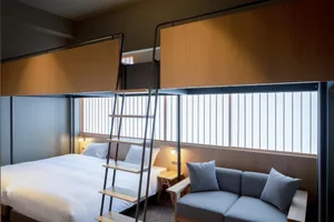 Modern bedroom featuring bunk beds made of wooden and steel materials.