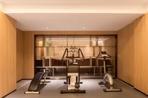 Modern workout room featuring exercise equipment and wooden paneling