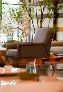 Interior design featuring a modern upholstered chair in a spacious living room.
