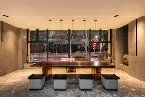 A modern lobby interior designed with concrete elements, featuring minimalist aesthetics and sleek furniture.