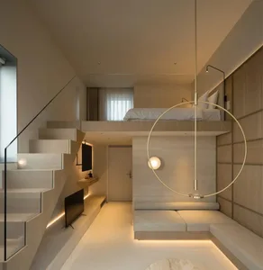 A modern residential studio apartment featuring wooden paneling and a loft bed.