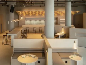 Modern restaurant interior featuring concrete and wood materials