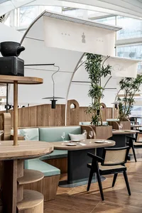 Modern restaurant interior with wooden furniture and leather accents