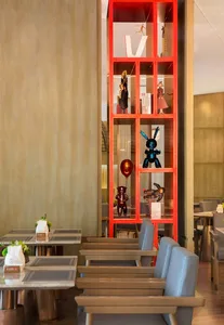 Modern restaurant interior showcasing wooden tables, glass shelves, and metal accents