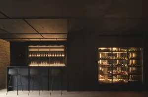 Well-designed modern wine bar with dark interiors and a focus on wine storage and tasting