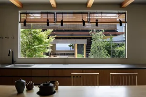 A contemporary kitchen with wooden cabinets and metallic accents.