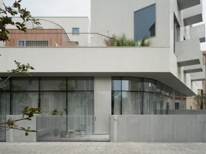 Modern urban residence featuring a contemporary exterior made of concrete and glass.