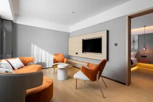 Modern living room featuring a contemporary sofa with a minimalist design, complemented by metal and leather accents.