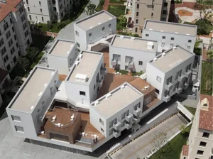 A modern residential building with a concrete exterior.