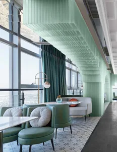 Modern restaurant interior with glass walls, concrete flooring, and tiled accents