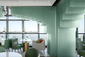 Modern restaurant interior with green acrylic and glass materials and a view of the cityscape from the large windows.
