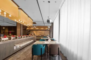 Modern restaurant interior with marble and concrete finishes, showcasing contemporary design elements.