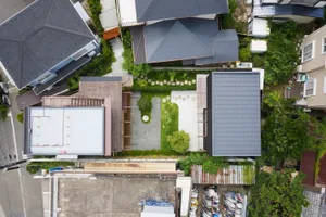 A modern yard featuring grass and plants, viewed from above.