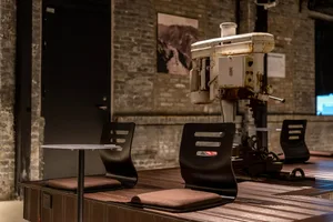 Industrially designed seating arrangement featuring a vintage drilling machine