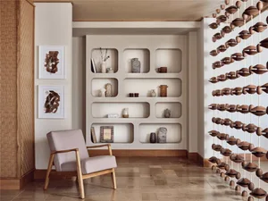 A minimalist interior space featuring wooden furniture and ceramic decor items on shelves.