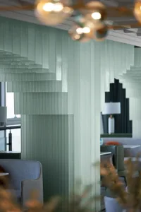 Modern minimalist office space with transparent glass walls creating a sleek and open environment.