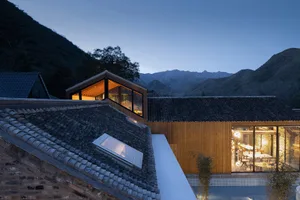 Modern minimalist residential architecture featuring wood, glass, and stone materials.