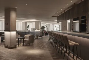 Modern bar concept featuring marble flooring and contemporary seating.
