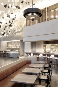 A modern casual restaurant featuring concrete, marble, and wooden elements.