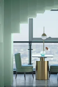 Modern living room featuring metal and glass furniture and decor.
