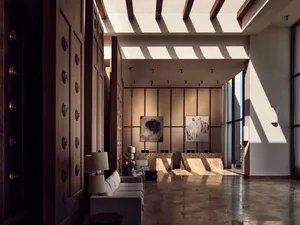 Modern lobby interior with marble flooring, white sofas, and abstract paintings on the wall.