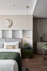 A modern minimalist bedroom with a large bed, textured headboard, and hanging chandelier.