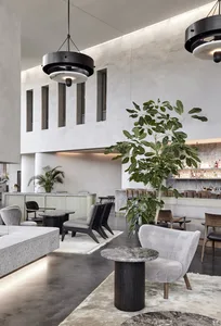 Modern restaurant interior with concrete, marble, and wooden finishes.