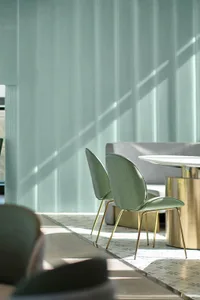 Modern restaurant seating area with metallic bronze tables and chairs, featuring a contemporary design with minimalistic seat