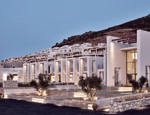 Modern hotel resort with white concrete architecture and stone ground pool.