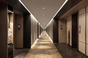 Modern, elegant hotel corridor lined with wooden tiles and featuring a long, empty hallway.
