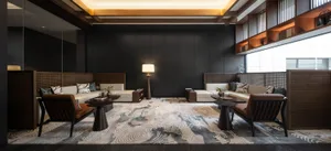 A modern living room featuring white sofas with textured fabric, dark wooden furniture, and a patterned rug.