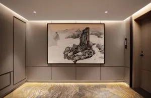 Modern lounge area with a wooden floor and wall textures, featuring a painting of a mountain landscape.