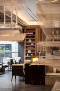 Contemporary restaurant design featuring black marble accents and mixed materials.