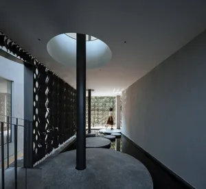 A modern interior design featuring a combination of concrete and glass materials.