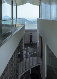 A modern interior design featuring concrete and glass materials