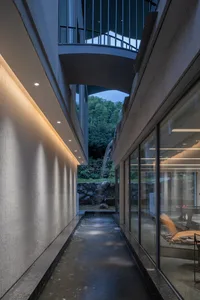 Concrete parking lot with modern architectural features, including exposed concrete walls and high ceilings.