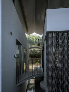 A modern residential house with a concrete facade and minimalist design features.