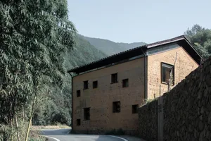A modern building constructed of stone, with a rustic yet contemporary design.