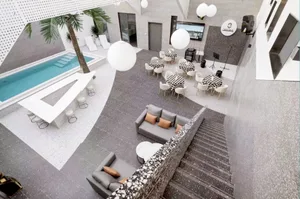 Modern interior space featuring concrete flooring with a pool and seating areas.