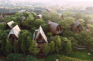 Modern residential treehouses surrounded by greenery, constructed from wood.