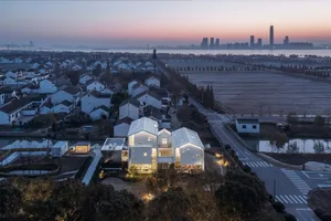 Modern residential buildings constructed with glass, concrete, and wood materials.
