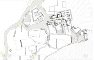 Floor plan of a modern residential building with various rooms and outdoor spaces.