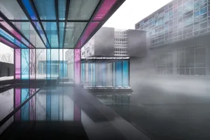 An office interior featuring modern architecture with glass, aluminum, and concrete materials.