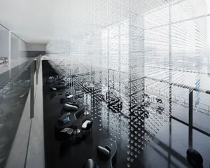 A modern hotel lobby featuring glass and concrete materials.