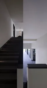 Concrete staircase with black steps in an industrial interior setting.