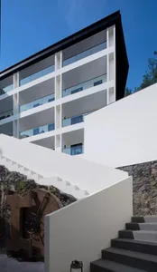 Modern building with white walls and glass windows.