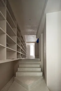 Modern concrete staircase interior with minimalistic design and natural lighting.