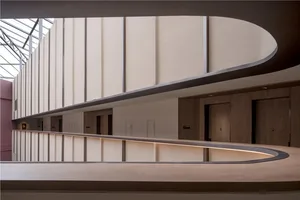 A modern corridor featuring wooden panels and doors.